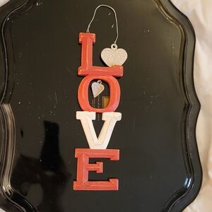 Wooden wall decoration spelling LOVE, with two medal hearts